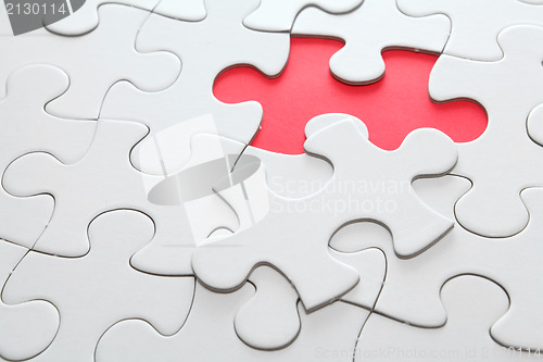 Image of puzzle with missing red piece