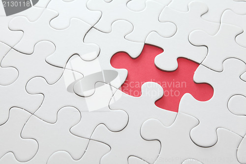 Image of puzzle with missing red piece 