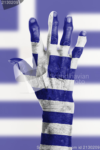 Image of Old hand with flag, European Union, Greece