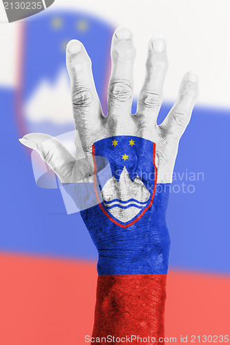 Image of Old hand with flag, European Union, Slovenia