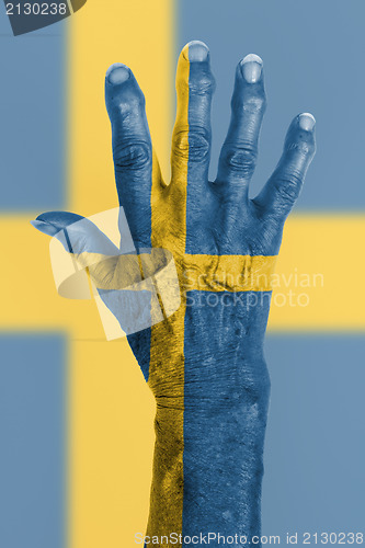 Image of Old hand with flag, European Union, Sweden