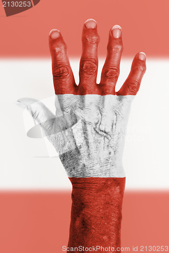 Image of Old hand with flag, European Union, Austria