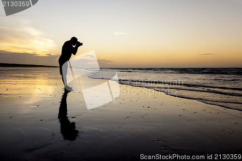 Image of photographer at the sunset beach