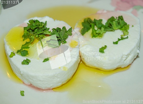 Image of Tomino cheese with rucola and olive oil