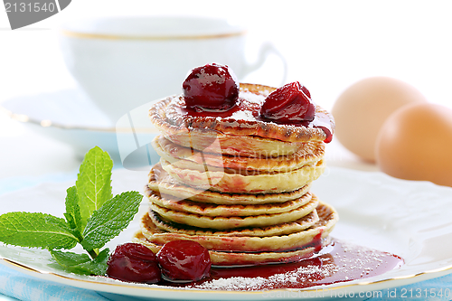 Image of Pancakes with cherry sauce.