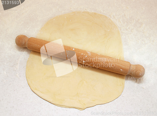 Image of Block of freshly made pastry rolled out on a floured work surfac