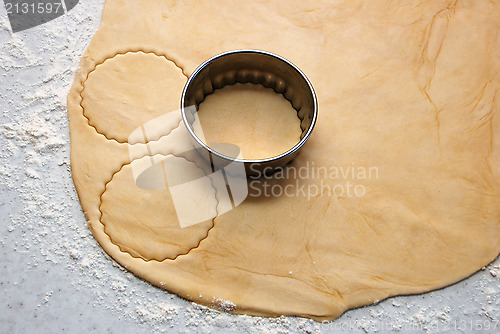Image of Metal cutter cutting out circles of pastry for jam tarts