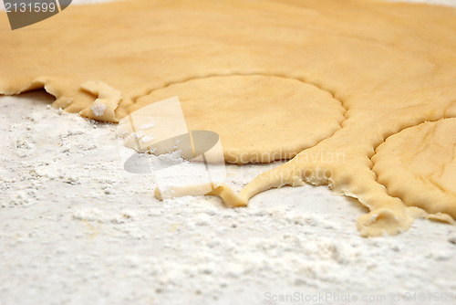 Image of Detail of circles being cut from a sheet of fresh pastry