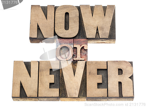 Image of now or never in wood type