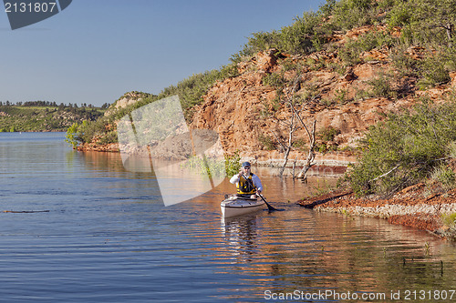 Image of canoe paddler on a mountain lake