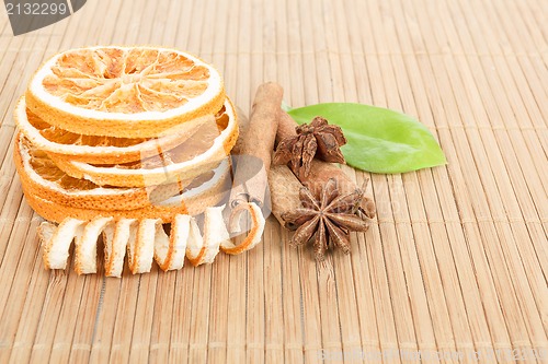 Image of Star Anise, cinnamon and dried orange wooden background 