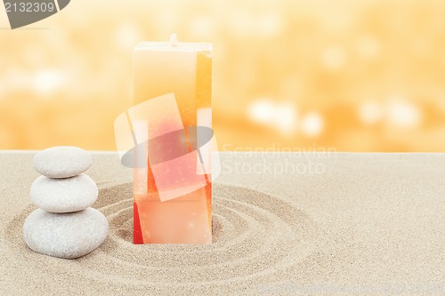 Image of Balance zen stones and candle in sand on bokeh 