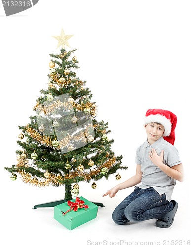 Image of happy boy in santa hat surprised by christmas present