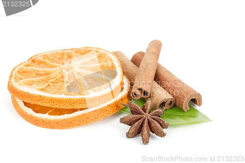 Image of Star Anise, cinnamon and dried orange and green leave on white