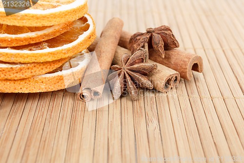 Image of Star Anise, cinnamon and dried orange wooden background 