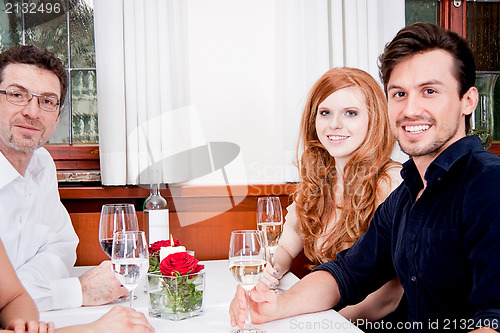Image of smiling happy people in restaurant
