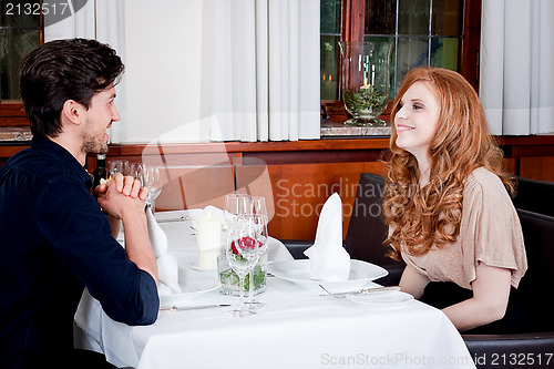Image of happy smiling couple in restaurant