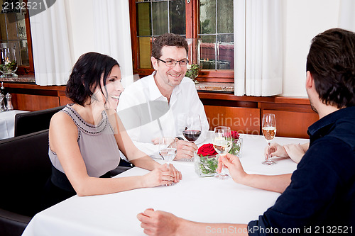 Image of smiling happy people in restaurant