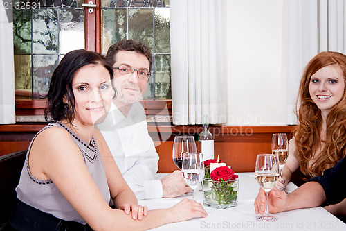 Image of smiling happy people in restaurant