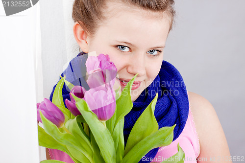 Image of smiling teenager girl with pink tulips bouquet 