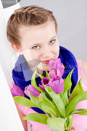 Image of smiling teenager girl with pink tulips bouquet 