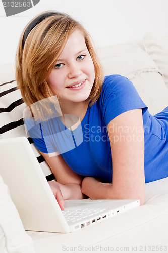 Image of young teenager girl with laptop smilig