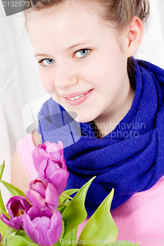 Image of smiling teenager girl with pink tulips bouquet 