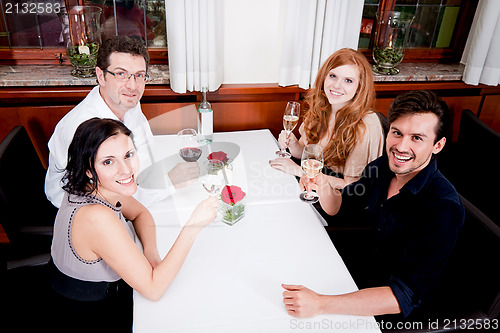 Image of smiling happy people in restaurant