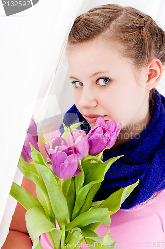 Image of smiling teenager girl with pink tulips bouquet 