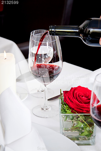 Image of couple drinking red wine in restaurant