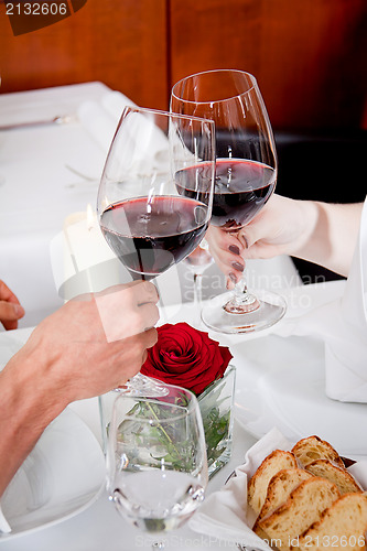 Image of couple drinking red wine in restaurant