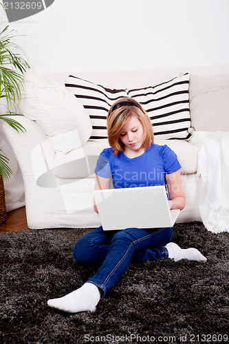 Image of young teenager girl with laptop smilig