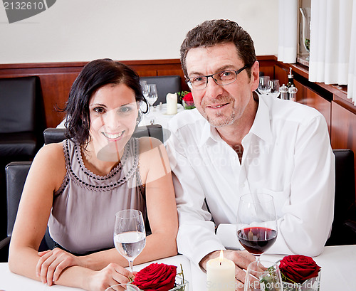 Image of smiling happy people in restaurant