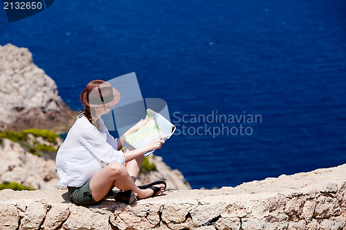 Image of young attractive woman with land map in summer
