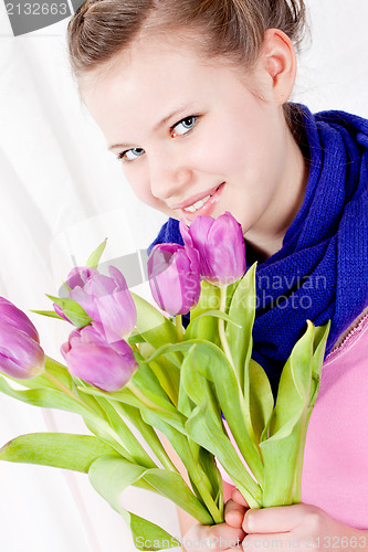 Image of smiling teenager girl with pink tulips bouquet 