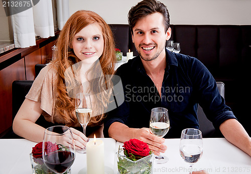 Image of smiling happy people in restaurant
