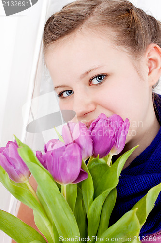 Image of smiling teenager girl with pink tulips bouquet 