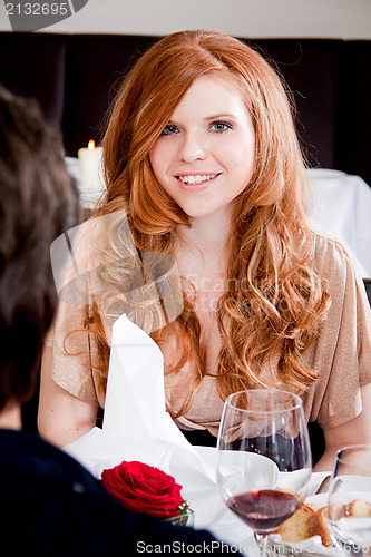 Image of couple drinking red wine in restaurant