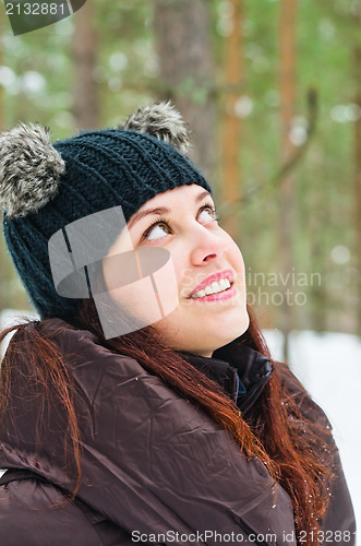 Image of Portrait of the charming young woman in winter outdoors 