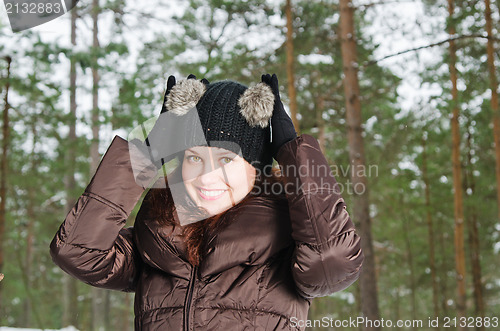 Image of Portrait of the charming young woman in winter outdoors 