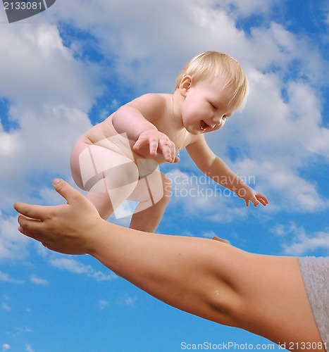 Image of toddler boy smiling in the sky