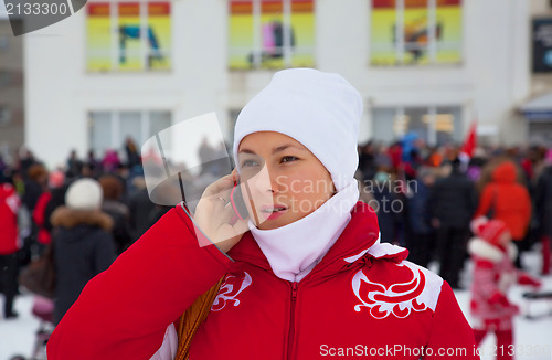 Image of The girl speaks on a mobile phone about sale in the supermarket