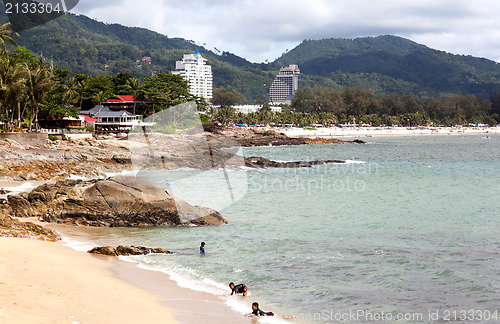 Image of Thai children are swimming in the wild beach. Editorial only.