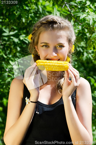 Image of woman eating corn-cob