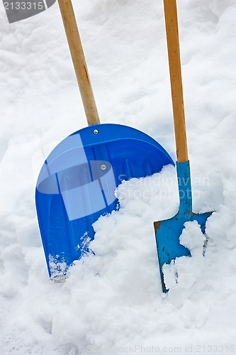 Image of Two Shovels In The Snow Heap