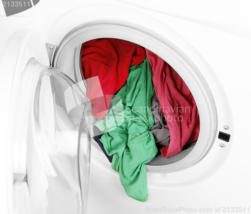 Image of Washing machine with clean colorful clothes