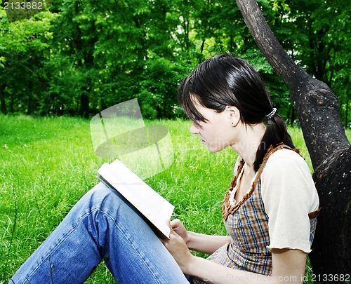 Image of Young woman reading a novel 