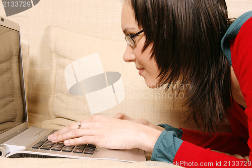 Image of Girl with laptop on the sofa 