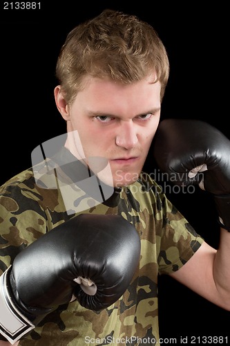 Image of angry young man in boxing gloves