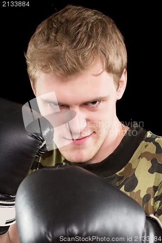 Image of grinning young man in boxing gloves